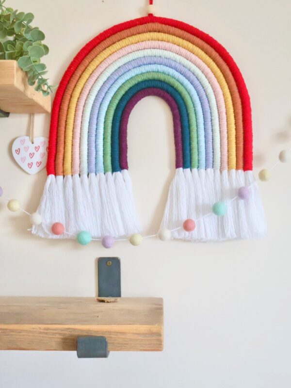 Vibrant 9-colour macramé rainbow wall hanging, perfect for nurseries, living rooms, or boho-inspired spaces