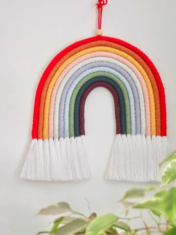 Vibrant 9-colour macramé rainbow wall hanging, perfect for nurseries, living rooms, or boho-inspired spaces